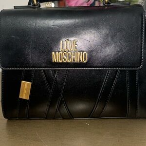 Black Love Moschino with gold letters.